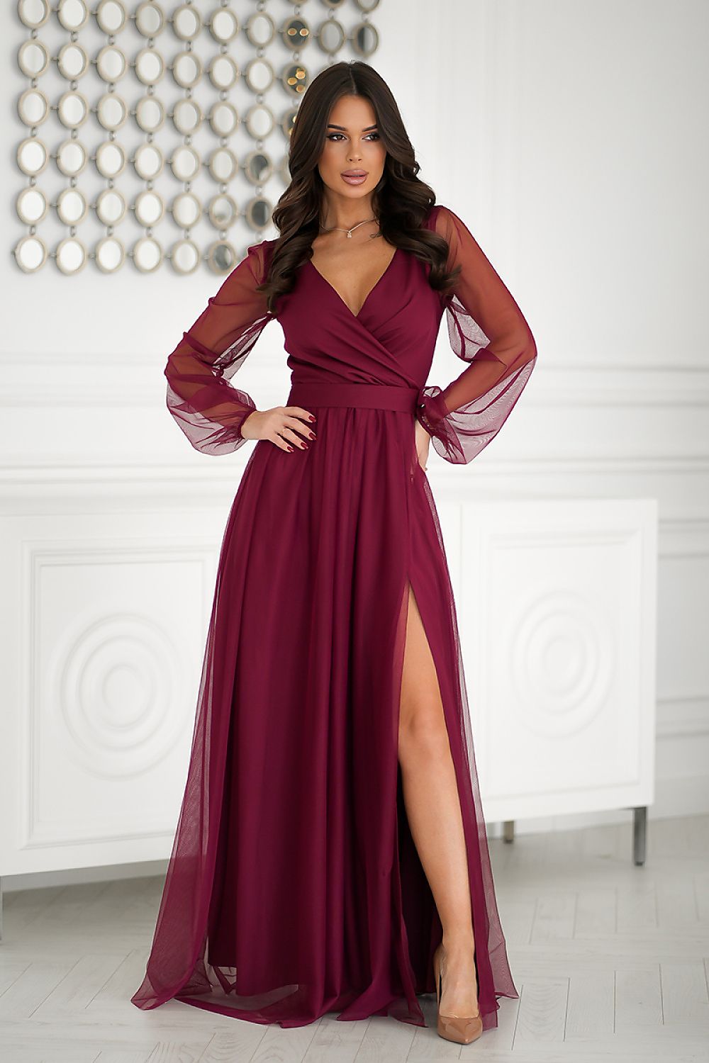 Elegant long dress by Bicotone featuring a graceful design and unique cutout, crafted from airy fabric, available in sizes EU 34-46.