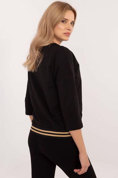 Lifestyle shot of an elegant casual blouse featuring 3/4 sleeves and rhinestone accents by Factory Price, ideal for sophisticated everyday looks in various sizes.