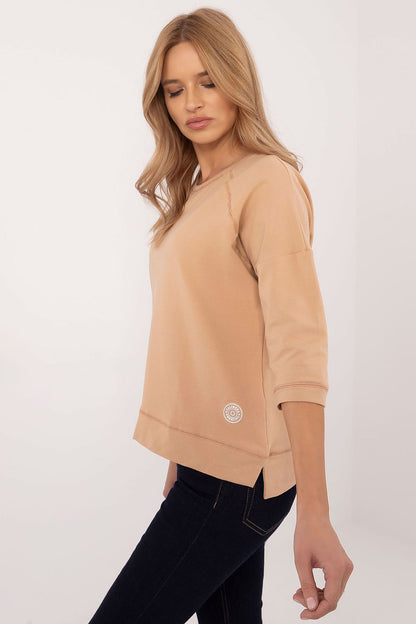 Sophisticated model wearing the Universal Casual Blouse by Factory Price, highlighting the breathable cotton blend and stylish 3/4 sleeves.