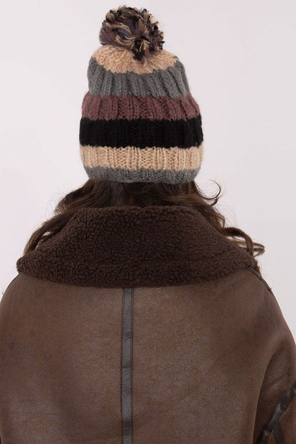 Luxurious winter beanie cap by AT featuring vibrant stripes and a fluffy pom-pom, ideal for stylish winter outings.