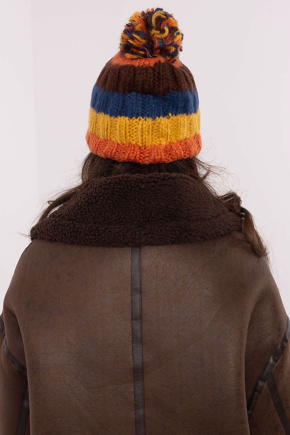 Fashion-forward winter beanie cap with bold striped design and a fluffy pom-pom by AT, perfect for any winter occasion.