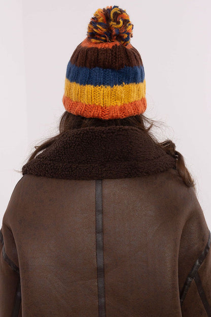 Fashion-forward winter beanie cap with bold striped design and a fluffy pom-pom by AT, perfect for any winter occasion.