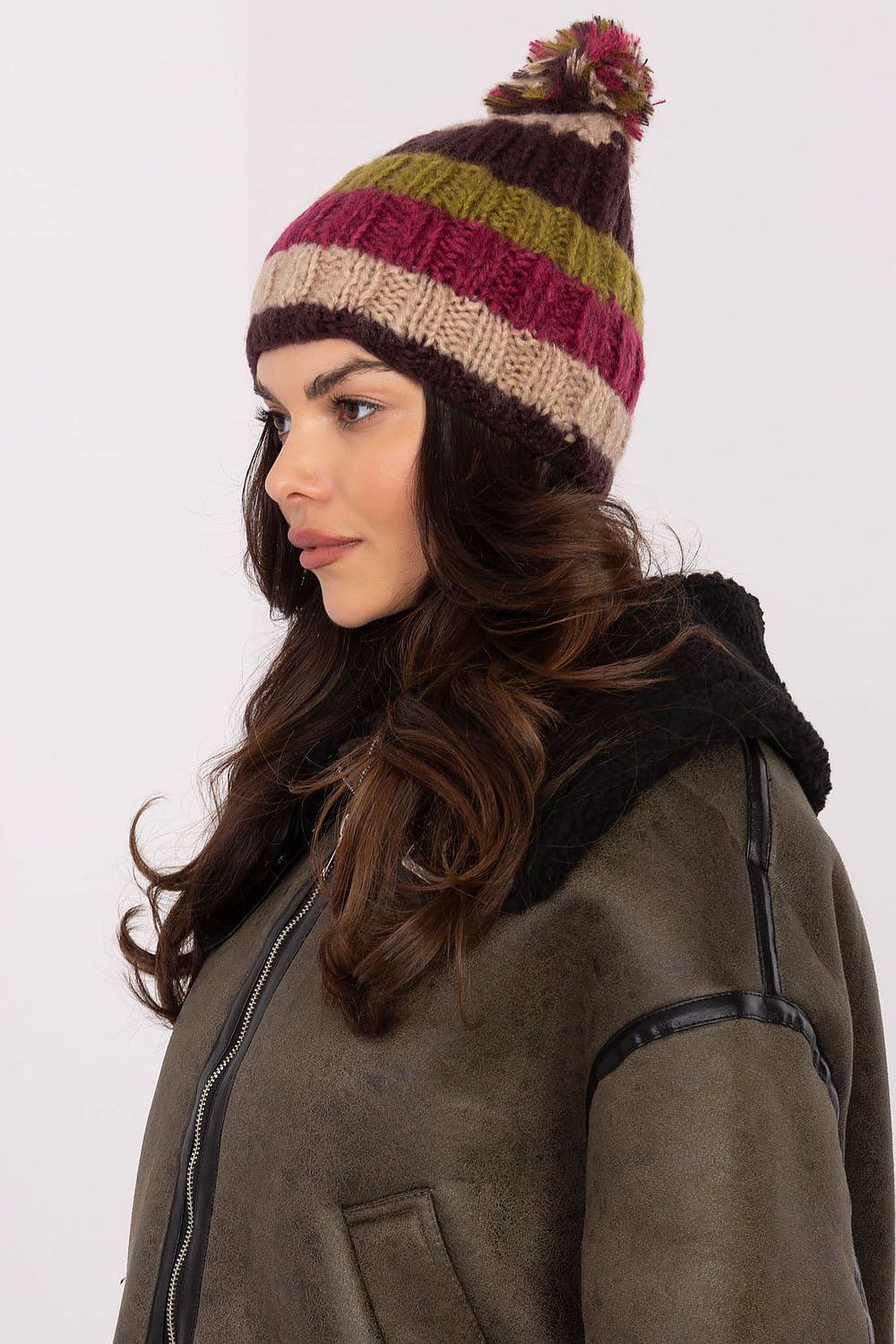 AT's chic winter beanie cap with vibrant stripes and fluffy pom-pom, designed for comfort and style this winter season.