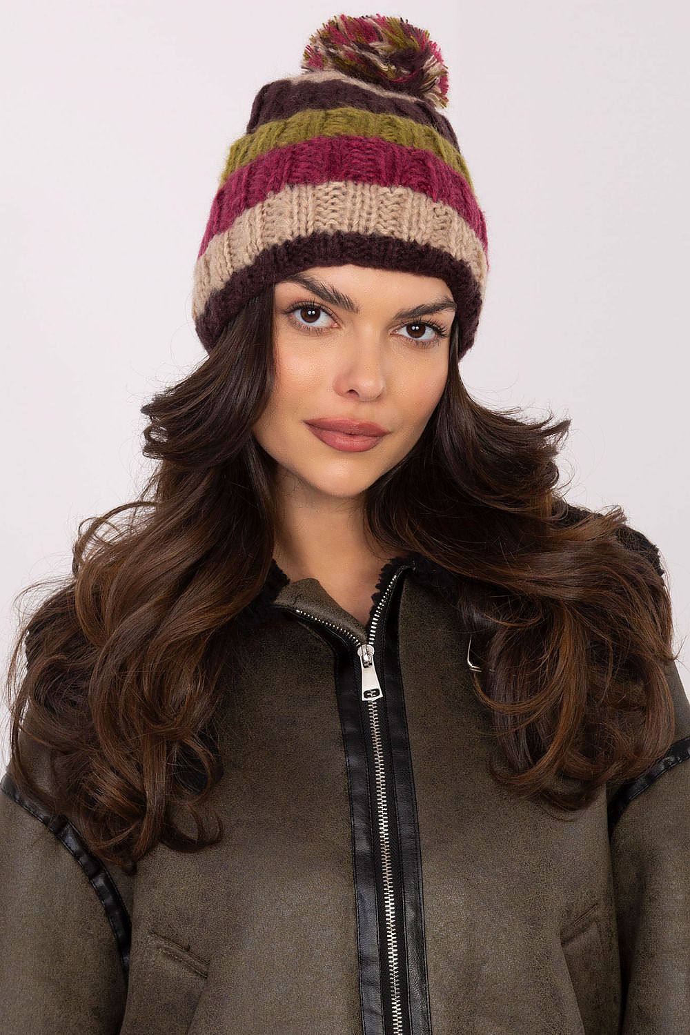 Fashionable winter beanie cap from AT, featuring eye-catching striped patterns and a plush pom-pom, perfect for stylish outdoor activities.