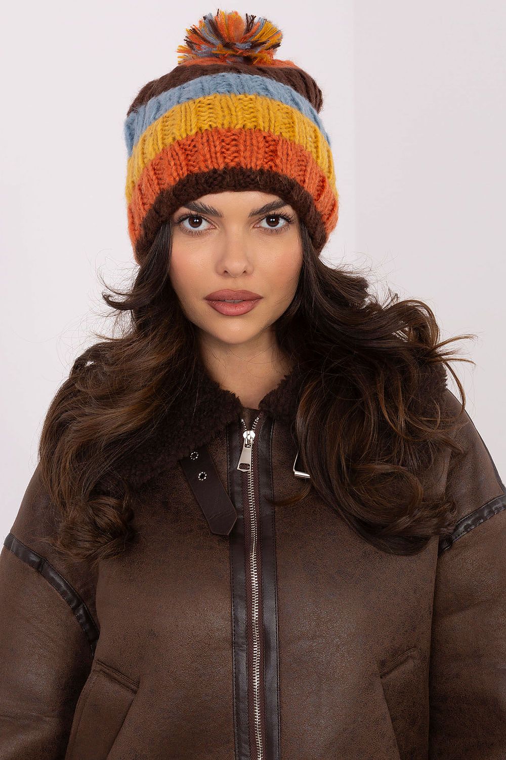 Luxurious beanie cap by AT with eye-catching colourful stripes and a soft pom-pom, perfect for winter elegance.