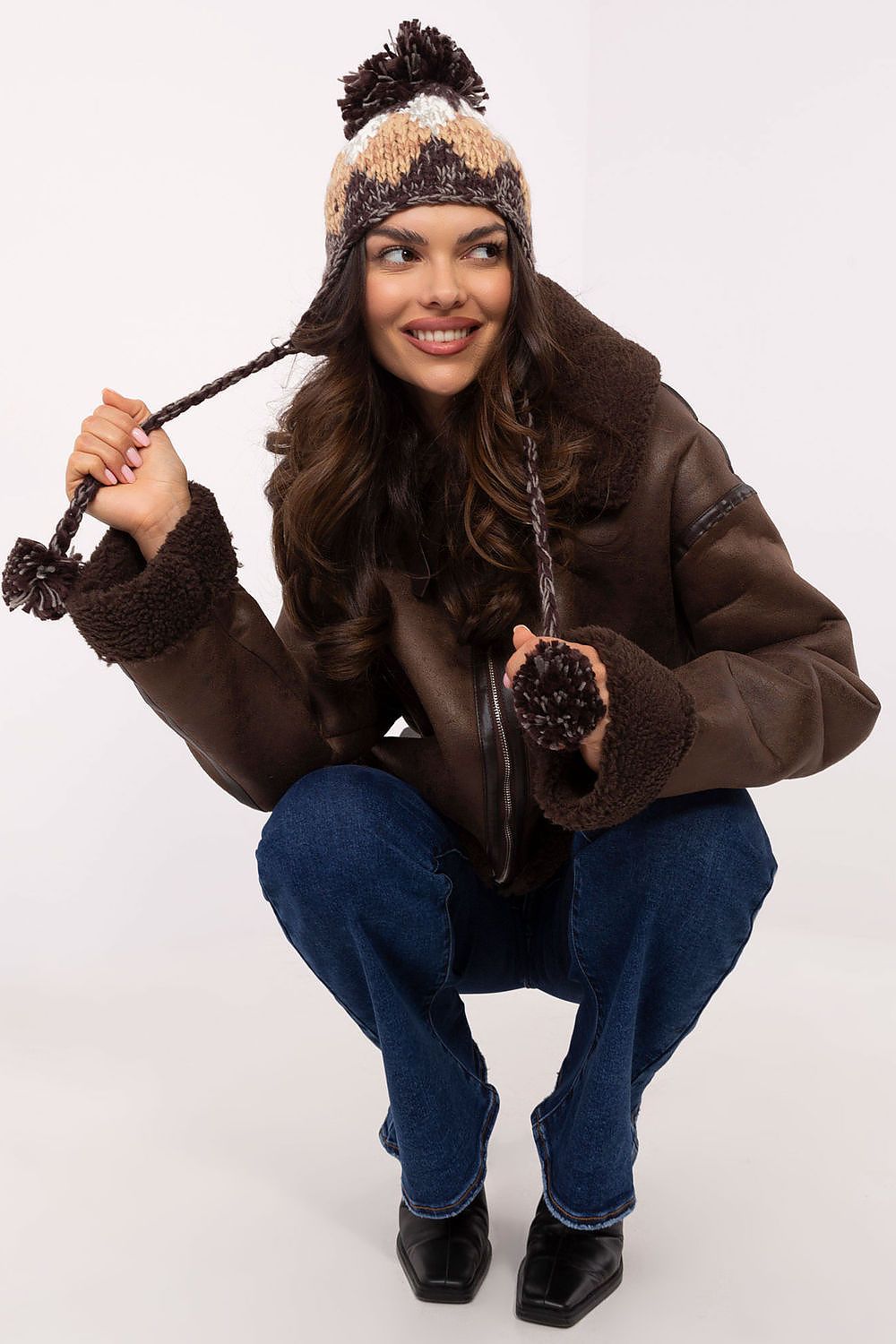 Elegant AT Winter Beanie for Women, showcasing a geometric diamond pattern and warm acrylic material, topped with a fluffy pom-pom.