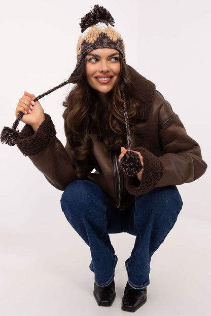 Elegant AT Winter Beanie for Women, showcasing a geometric diamond pattern and warm acrylic material, topped with a fluffy pom-pom.