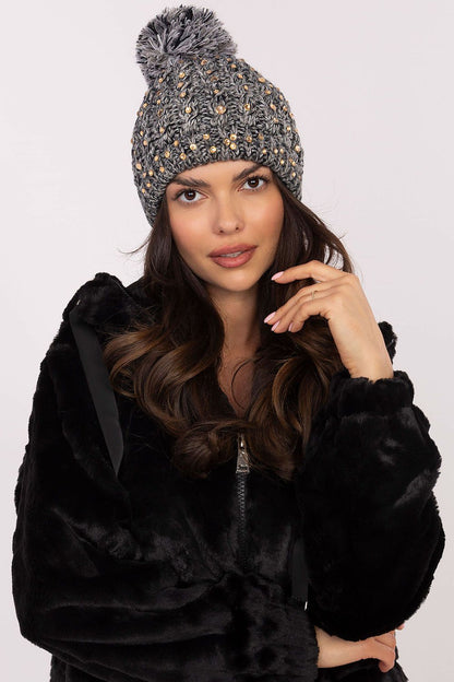 Luxury women's beanie hat by AT featuring a fluffy pom-pom and sparkling zircon accents, crafted from warm acrylic for stylish winter comfort.