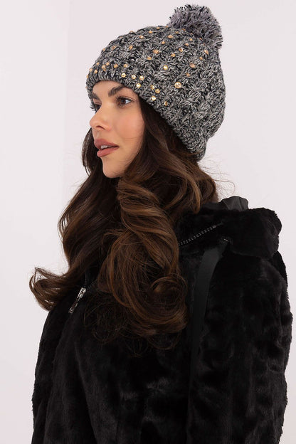 Elegant warm acrylic winter cap for women by AT, adorned with delicate zircons and a chic pom-pom, perfect for adding a luxurious touch to winter outfits.