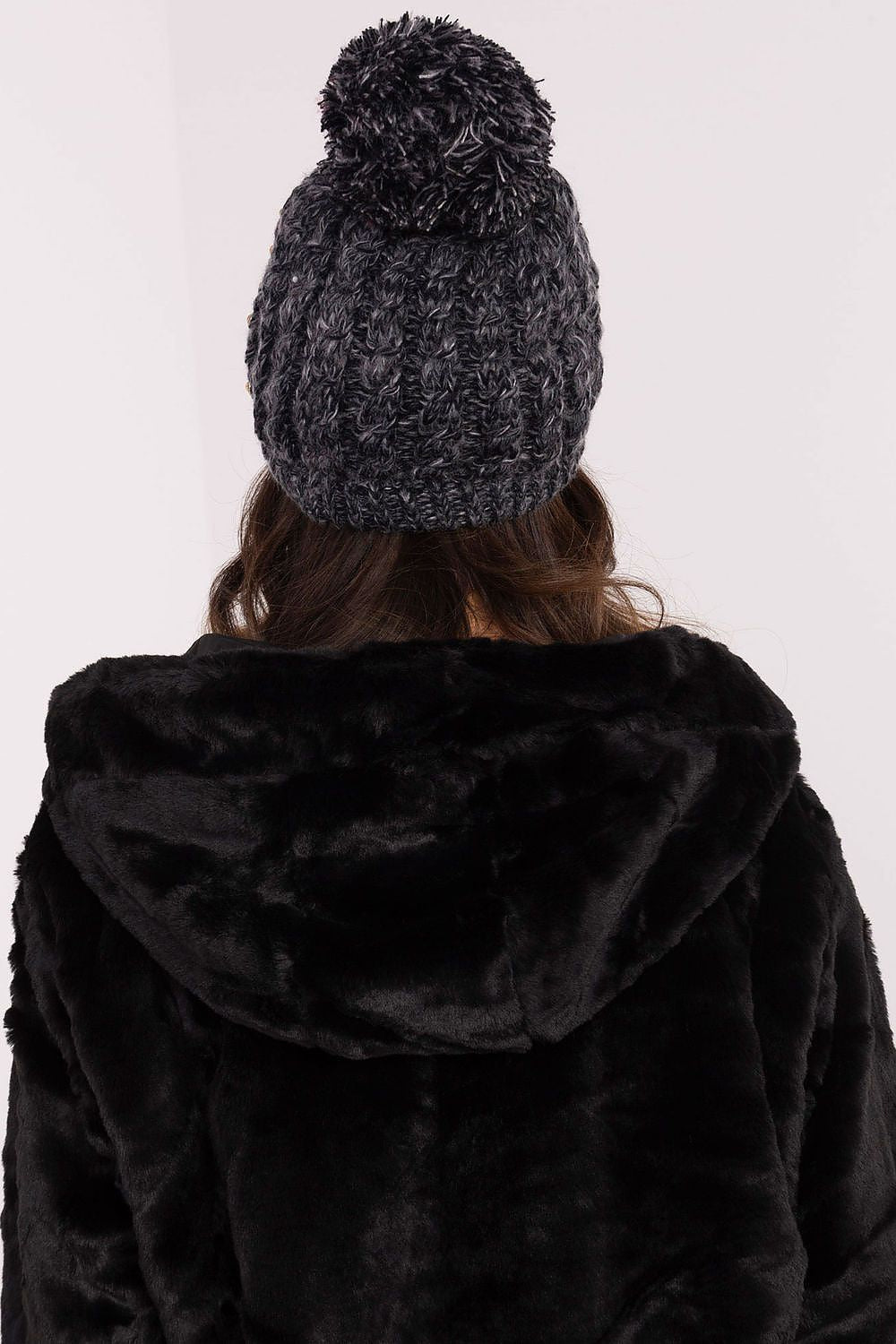 Stylish and warm women's beanie by AT, adorned with a fluffy pom-pom and elegant zircon details, ideal for both casual and formal winter occasions.