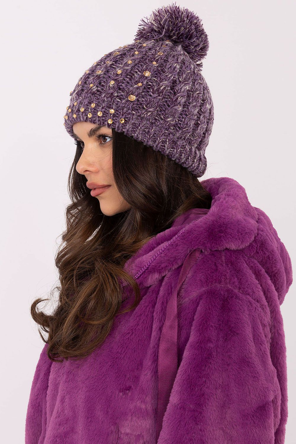 Elegant AT branded women's winter beanie cap in soft material, featuring delicate zircon accents and a fashionable fluffy pom-pom.