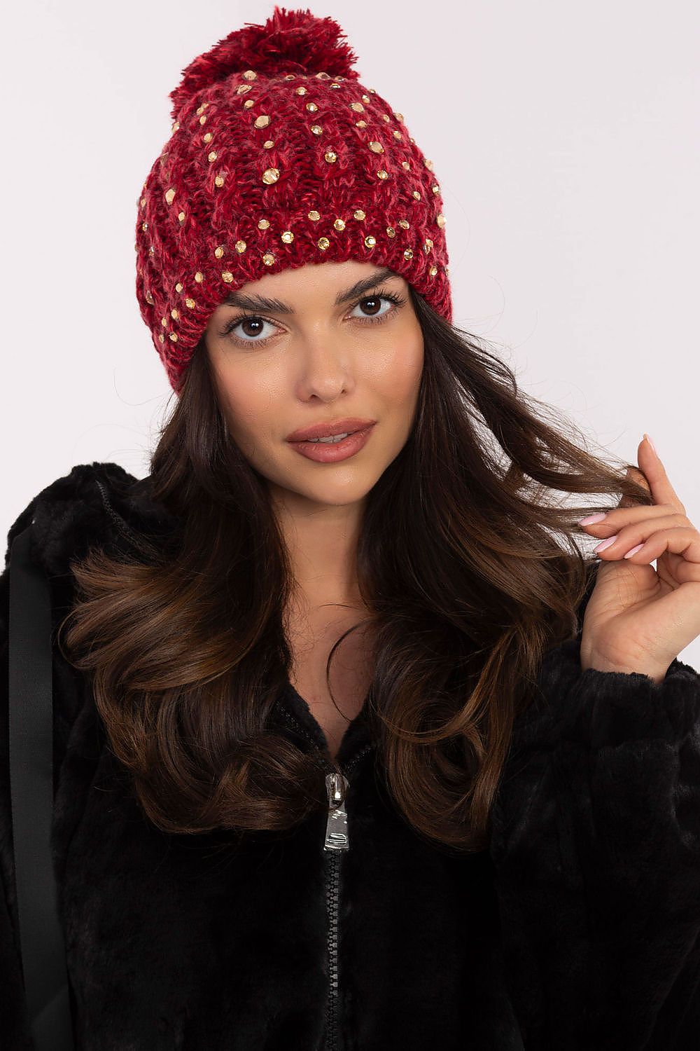 Elegant women's beanie cap with fluffy pom-pom and zircon accents by AT, perfect for winter style and warmth.