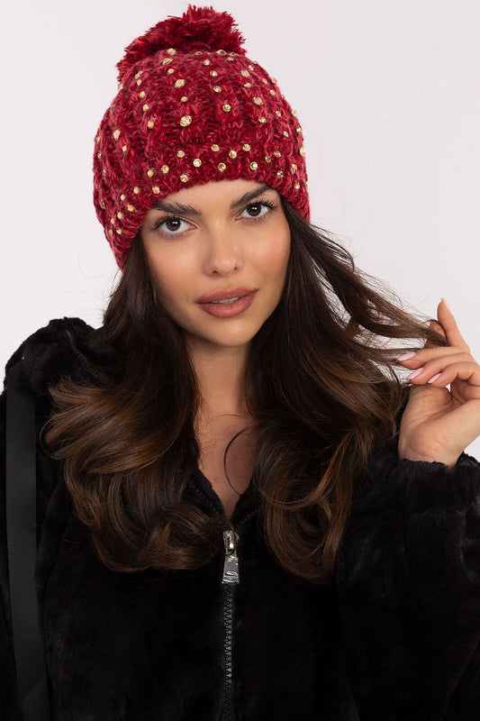 Elegant women's beanie cap with fluffy pom-pom and zircon accents by AT, perfect for winter style and warmth.