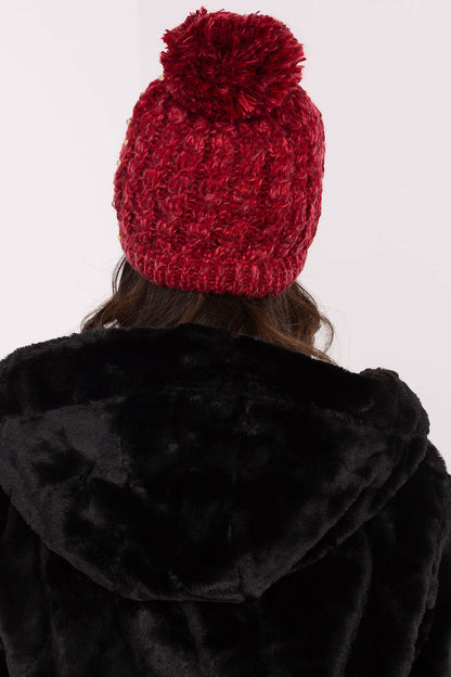Warm and stylish beanie for women by AT, adorned with a fluffy pom-pom and delicate zircon details, perfect for cold weather.