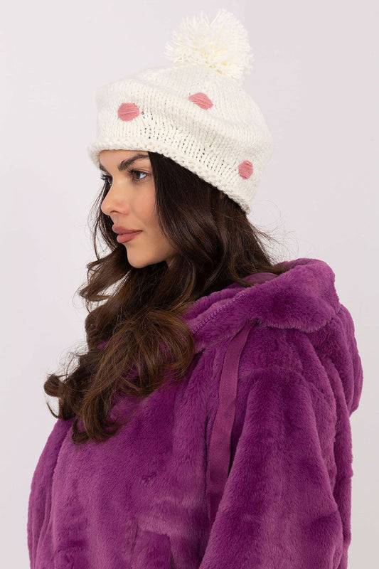 Luxury women's winter beanie hat from AT, featuring a fluffy pom-pom and decorative dots, crafted from soft acrylic fabric for optimal comfort and style.