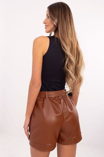 Chic styling of Italy Moda's eco leather shorts, emphasizing their elegant silhouette and practical slip pockets, perfect for versatile styling options.