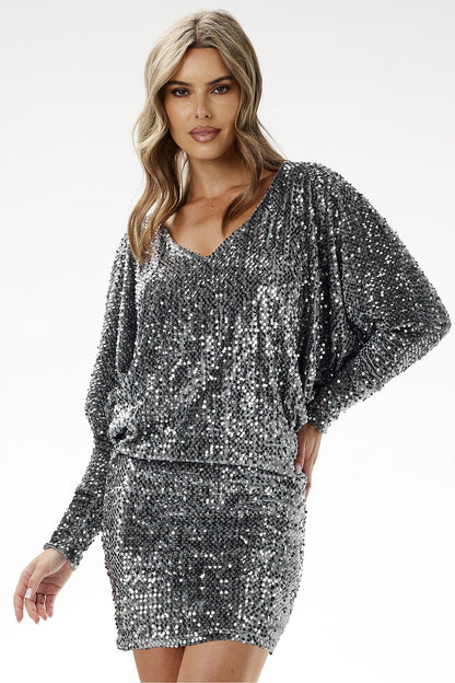 Model wearing the awama Sequin Mini Dress, demonstrating its stylish boat neckline and flattering mini cut.