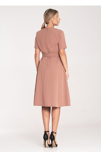 Model wearing the Figl classic midi dress in a stylish pose, highlighting the flattering boat neckline and sophisticated silhouette.