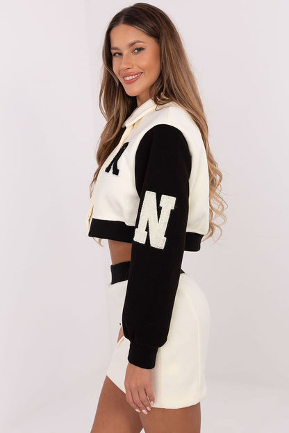 Close-up of the embroidered details on the women's polyester blouse from NM, showcasing luxurious craftsmanship in a fashionable casual set.