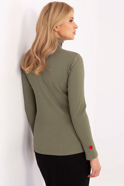 Stylish model showcasing the Elegant Women's Turtleneck Sweater with embroidered hearts by Relevance, perfect for both work and casual wear.