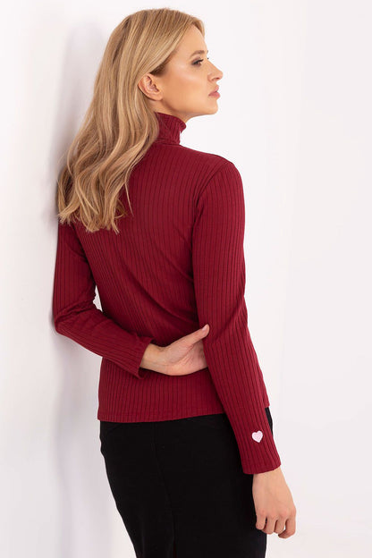 Flat lay of the Relevance women's turtleneck sweater emphasizing the rich cotton-spandex fabric and intricate embroidered hearts, ideal for luxury casual wear.
