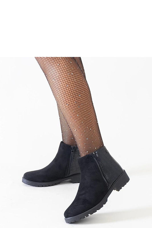 Close-up view of Solea eco-suede ankle boots featuring a chic crocodile skin pattern, perfect for elegant winter outfits.