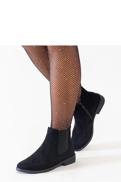 Close-up of Solea eco-suede ankle boots showcasing the almond toe and flat heel for stability and style.