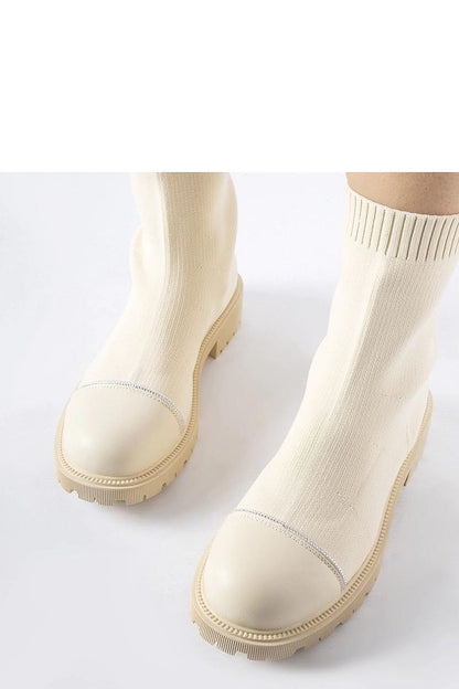 Close-up view of Solea luxurious beige sock boots featuring sparkling Vail zircons, perfect for adding a touch of elegance to both casual and formal outfits.