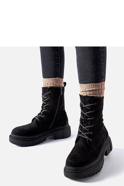 Stylish ensemble featuring Solea black eco leather trapery boots, exemplifying luxury and warmth for chilly seasons.