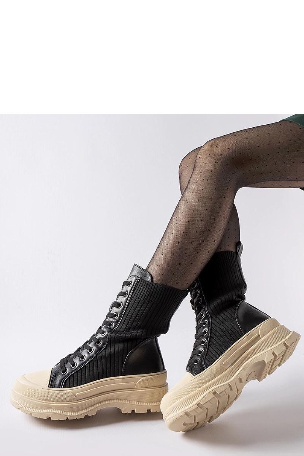 Elegant Solea black sock boots with a light sole, showcasing their chic design and perfect for sophisticated outfits.