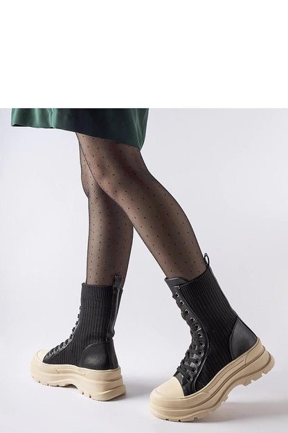 Solea black sock boots beautifully styled with casual and formal attire, offering versatile elegance for every occasion.