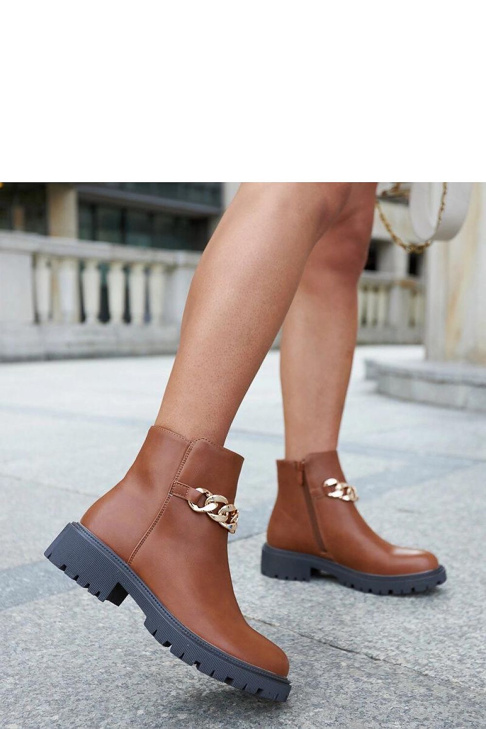 Elegant Brown Vegan Leather Ankle Boots adorned with Chain by Solea, showcasing a stylish round toe and flat heel, ideal for autumn and winter.