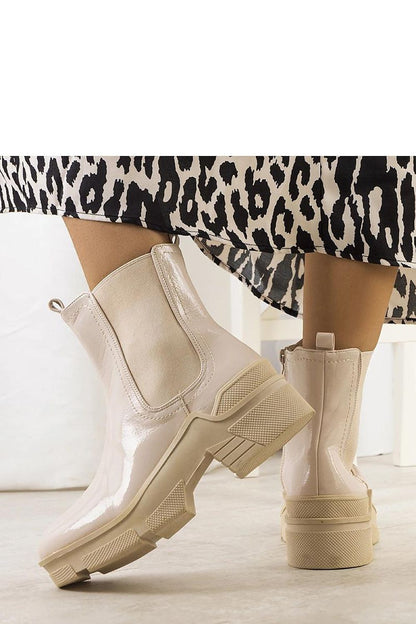 Close-up view of Solea's luxury beige patent leather ankle boots Asma showcasing high-quality craftsmanship and elegant design.