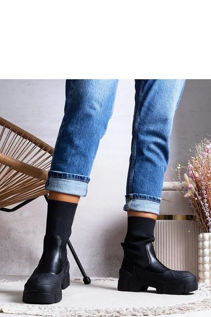 Solea ladies' black ankle boots with decorative embossing and a durable black rubber sole, offering a sophisticated look.