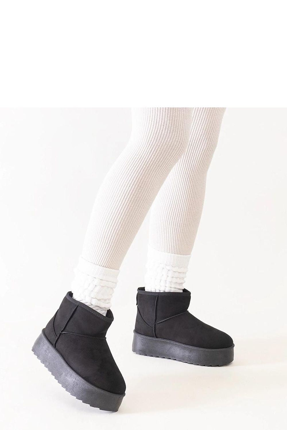 Solea Women's Black High Platform Snow Boots worn by a fashionable model outdoors in a winter setting, demonstrating their chic look and comfort.