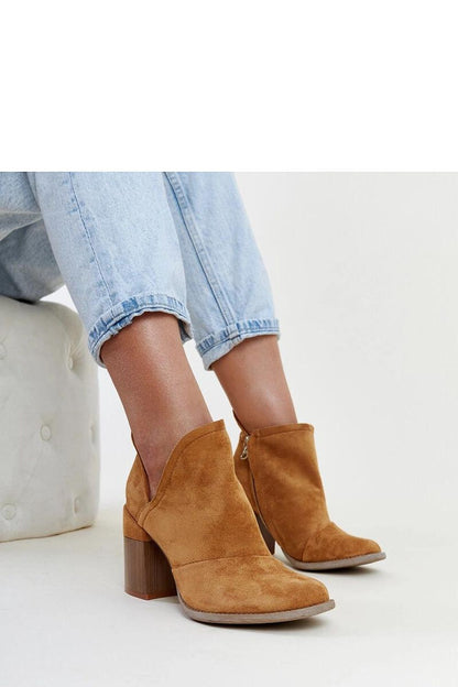 Luxury elegant brown ankle boots with cut-out heel by Solea, designed for winter style, featuring a high heel and zipper closure.