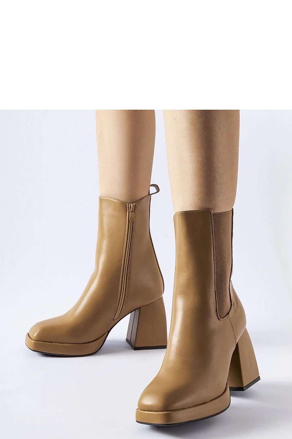 Solea's stylish beige insulated heel boots displayed on a fashionable model, demonstrating versatility for both casual and elegant winter outfits.