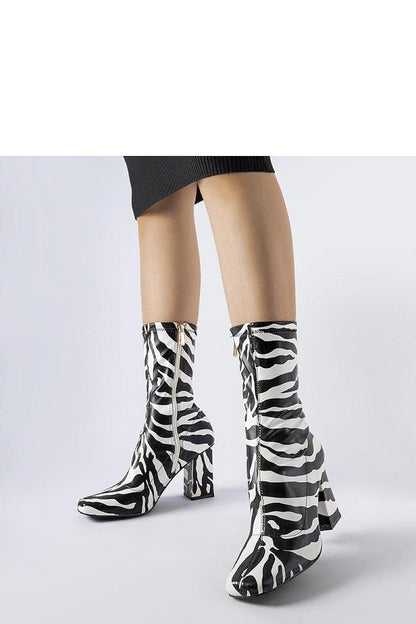 Solea's luxurious green Upland stiletto boots displayed in an autumn setting, showcasing their elegant silhouette and versatile style.