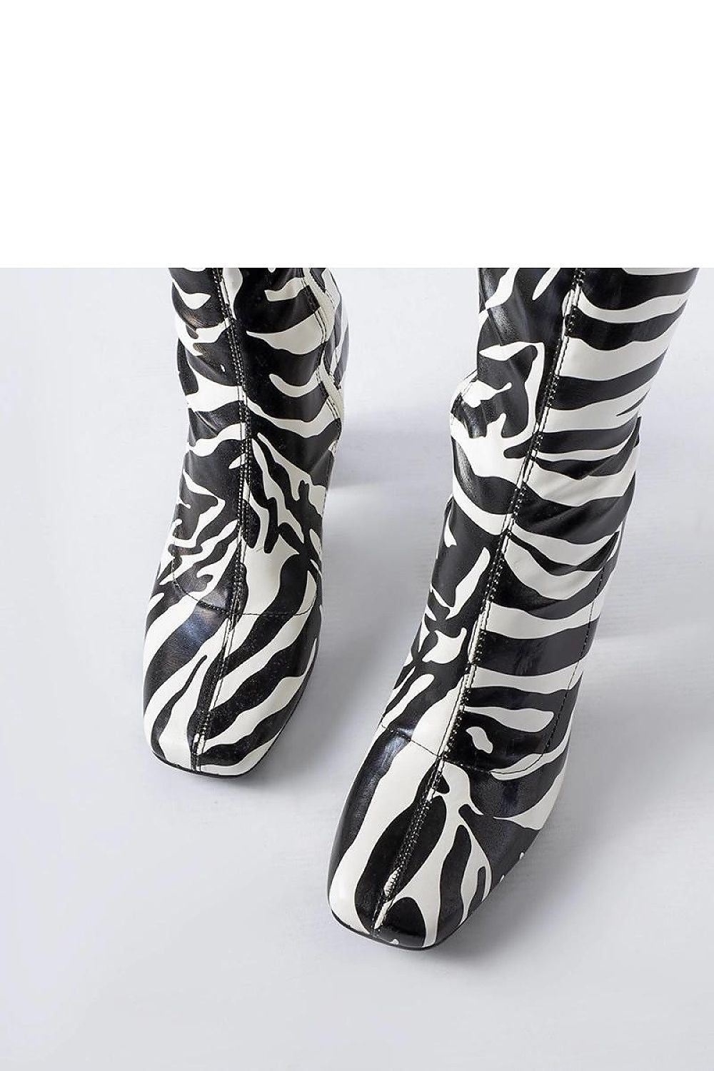 Side profile of the green Upland stiletto boots by Solea, demonstrating their sleek design and ankle-length appeal for fashionable women.