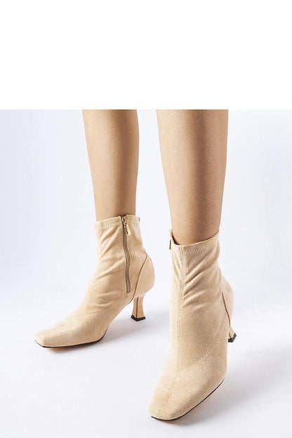 Solea's pink low-heeled eco leather boots arranged elegantly with a beige sole, embodying luxury and practicality for elegant autumn and winter outfits.