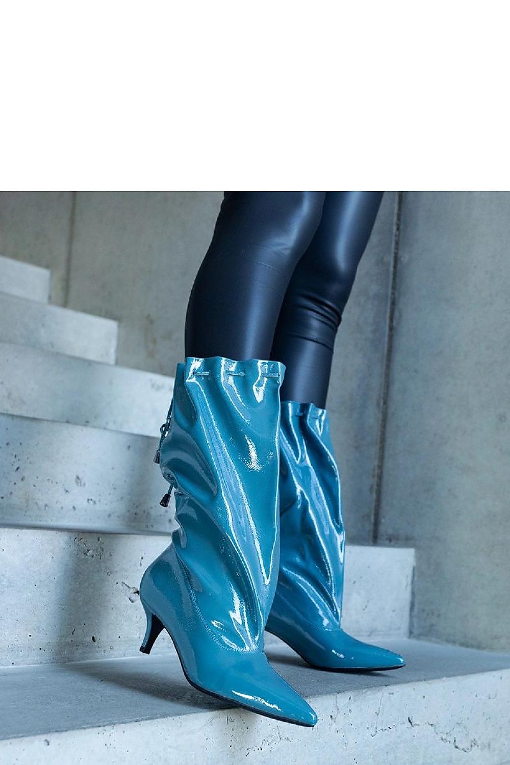 Stylish Solea Clinton low stiletto boots in blue eco leather, showcasing their warm interior and sophisticated slip-on design for comfort.