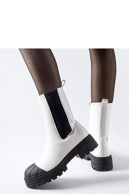 Fashionable Solea white insulated sable boots on a snowy background, embodying style and comfort for cold weather.