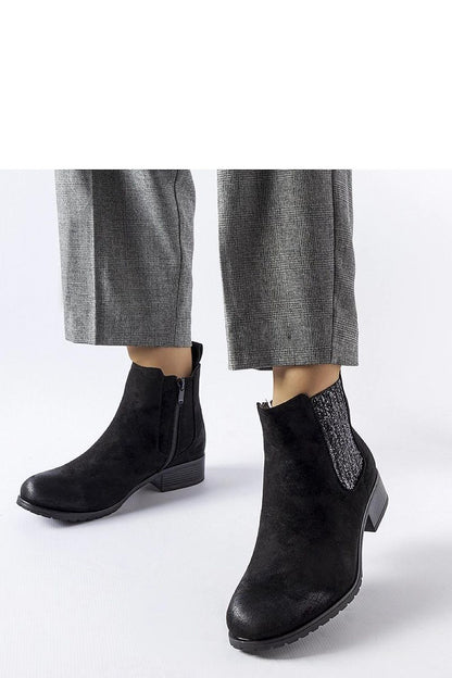 Solea Black Arnoux flat winter boots featuring a luxurious warm lining, stylish decorative inserts, and a comfortable flat heel, perfect for winter fashion.