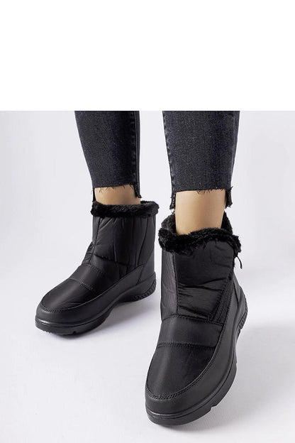 Close-up of Solea's black insulated snow boots showcasing the durable rubber sole and elegant design, perfect for winter fashion.