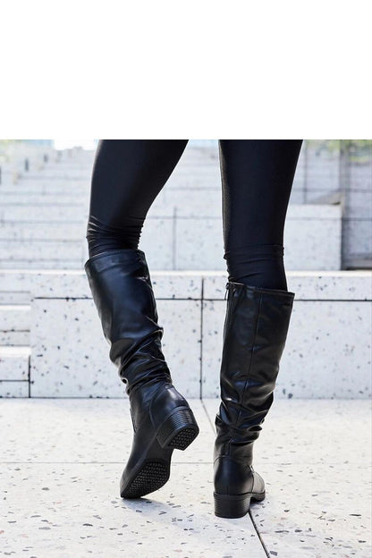 Stylish black thigh-high boots from Solea, designed for versatility with formal and casual outfits, made of durable eco leather materials.