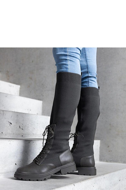 Luxury green thigh-high boots by Solea showcasing a flexible fabric upper, ideal for winter fashion.