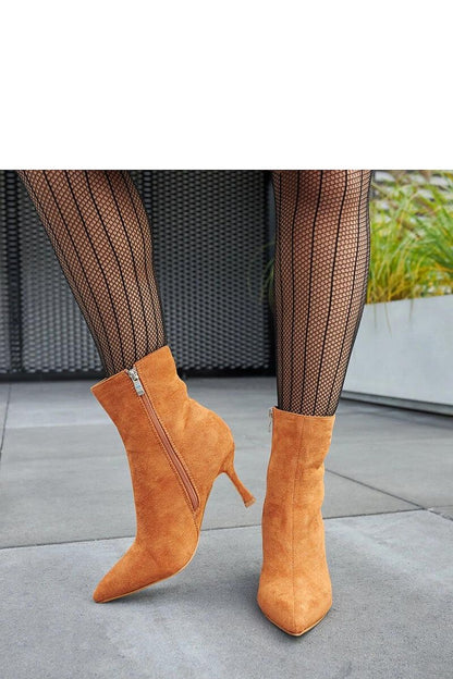 Solea Guimond Low-Heeled Ankle Boots in Warm Brown, styled with a fashionable dress, ideal for winter elegance and comfort.