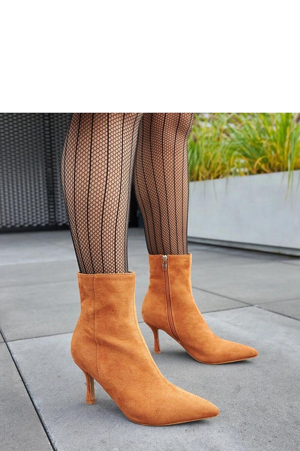 Solea Guimond Low-Heeled Ankle Boots in Warm Brown, showcasing versatility in pairing with both pants and skirts for stylish winter outfits.