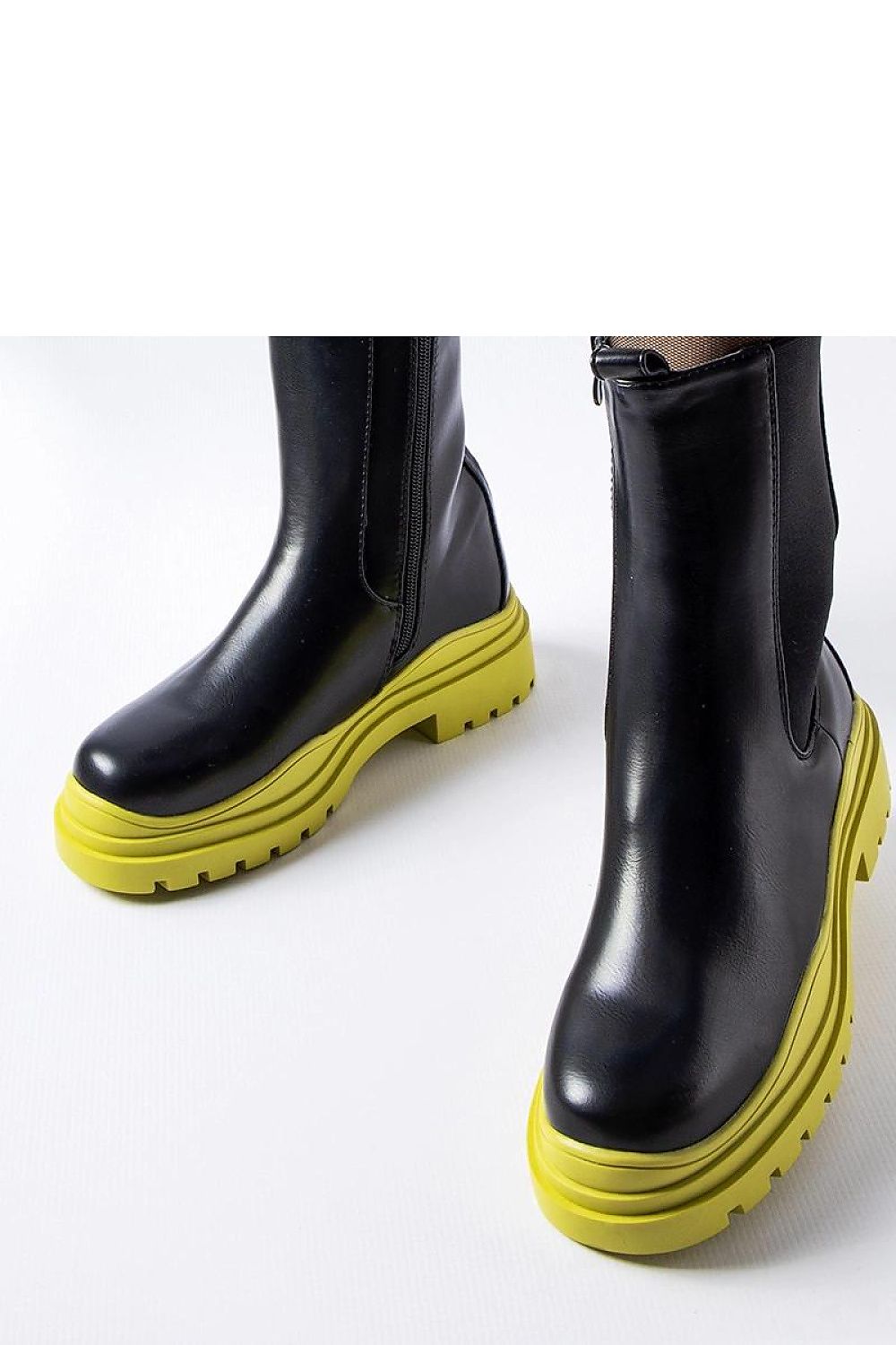 Close-up of Solea Black Ankle Boots with Colourful Green Sole, highlighting the elegant zipper lace-up feature and comfortable flat heel.