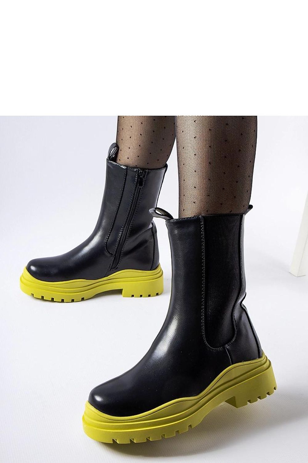 Solea Black Ankle Boots with Colourful Green Sole displayed in a fashionable setting, perfect for chic city walks and evening gatherings.